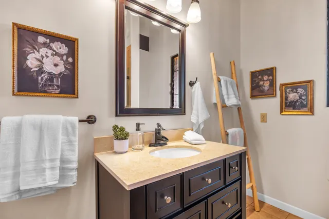 a bathroom with a sink vanity and a mirror