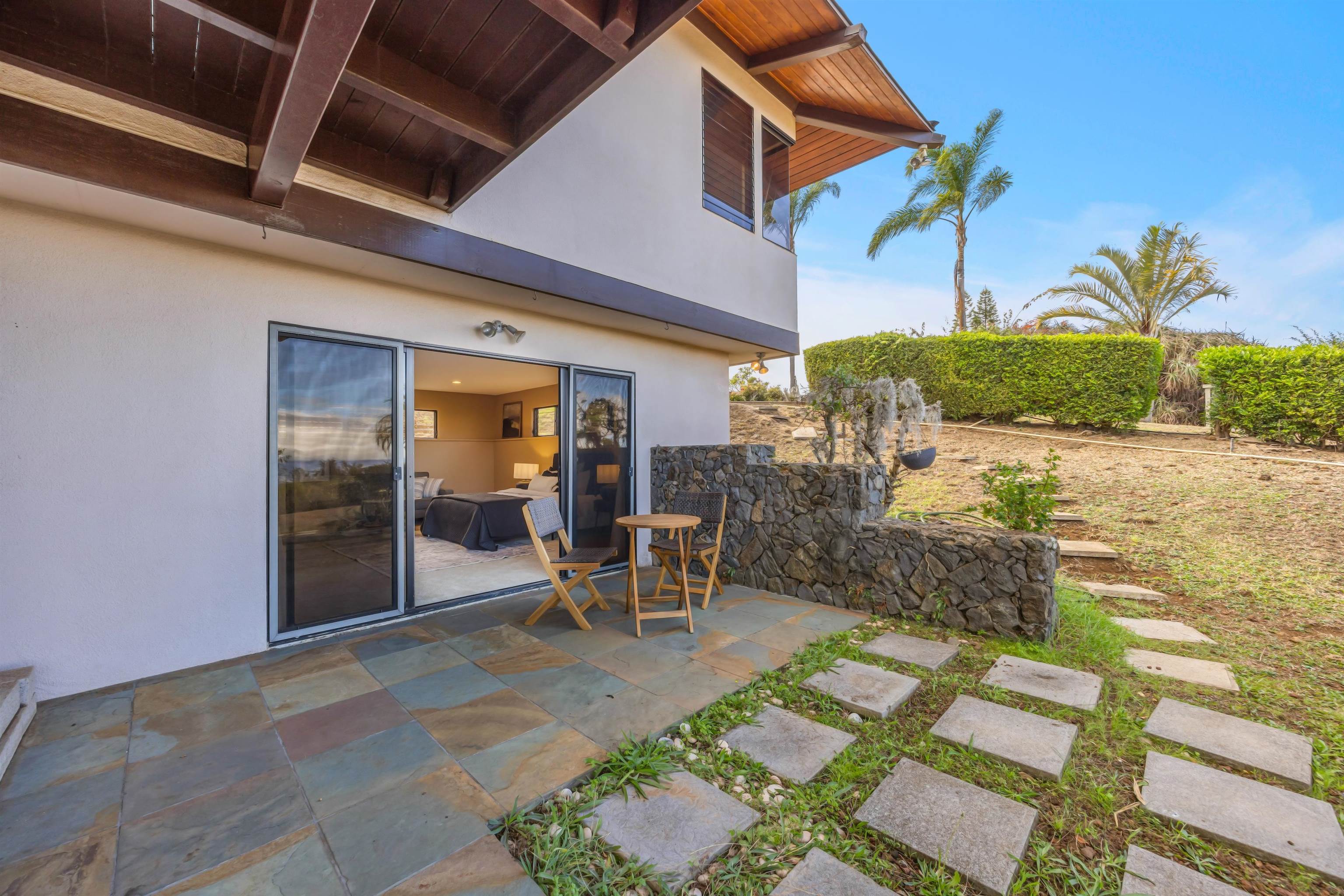 110 Kamehameiki Road Kula, HI 96790 - Photo 24 of 50 a view of a patio with table and chairs with wooden floor and fence