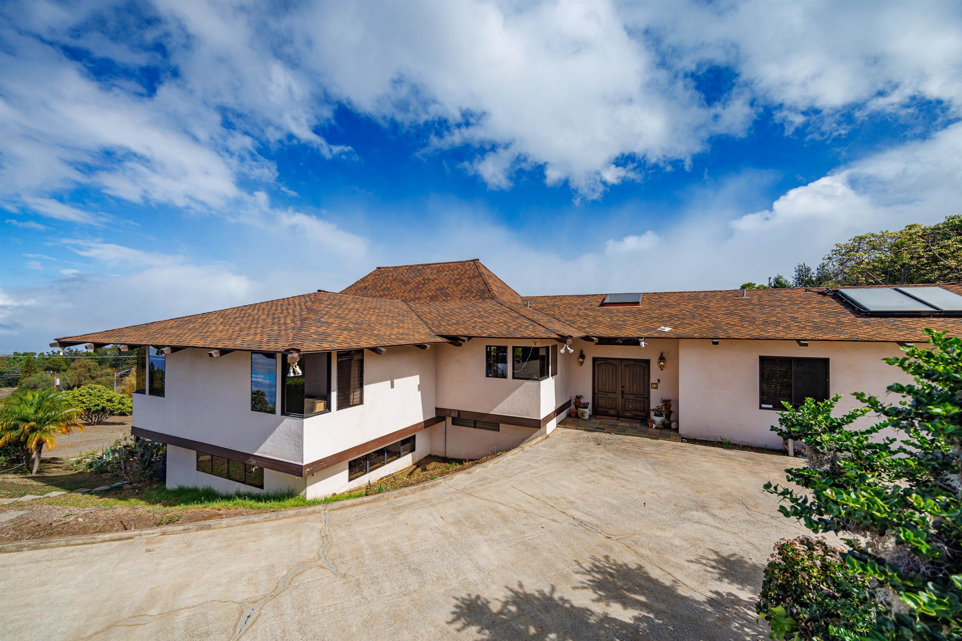 110 Kamehameiki Road Kula, HI 96790 - Photo 27 of 50 a view of a white house with a big yard and large tree