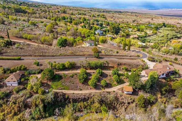 a view of a yard with wooden fence