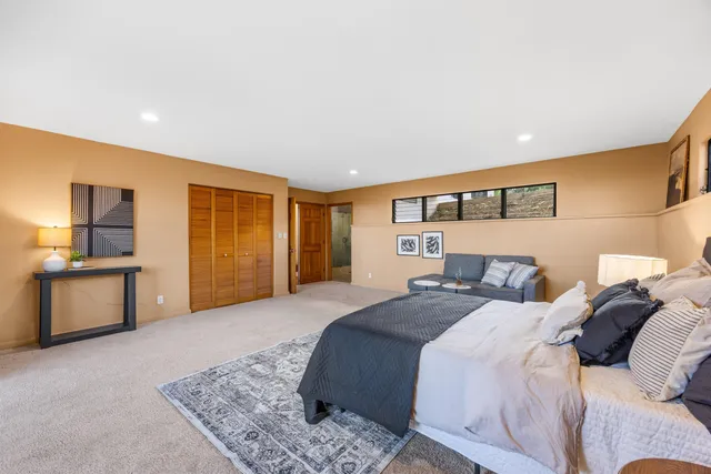 a spacious bedroom with a bed and furniture