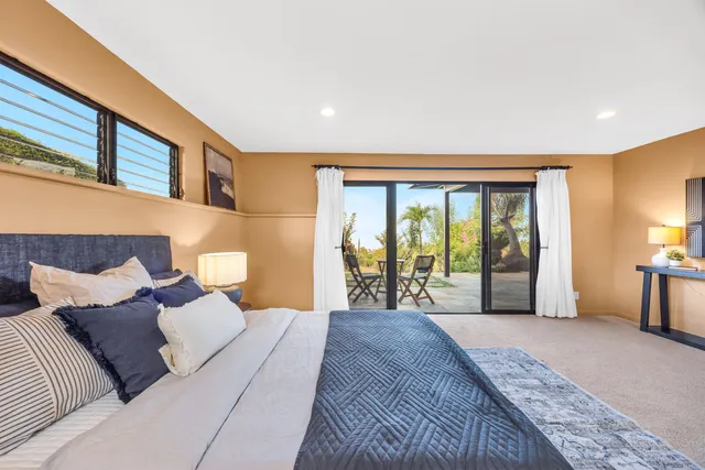 a spacious bedroom with a large bed and a large window