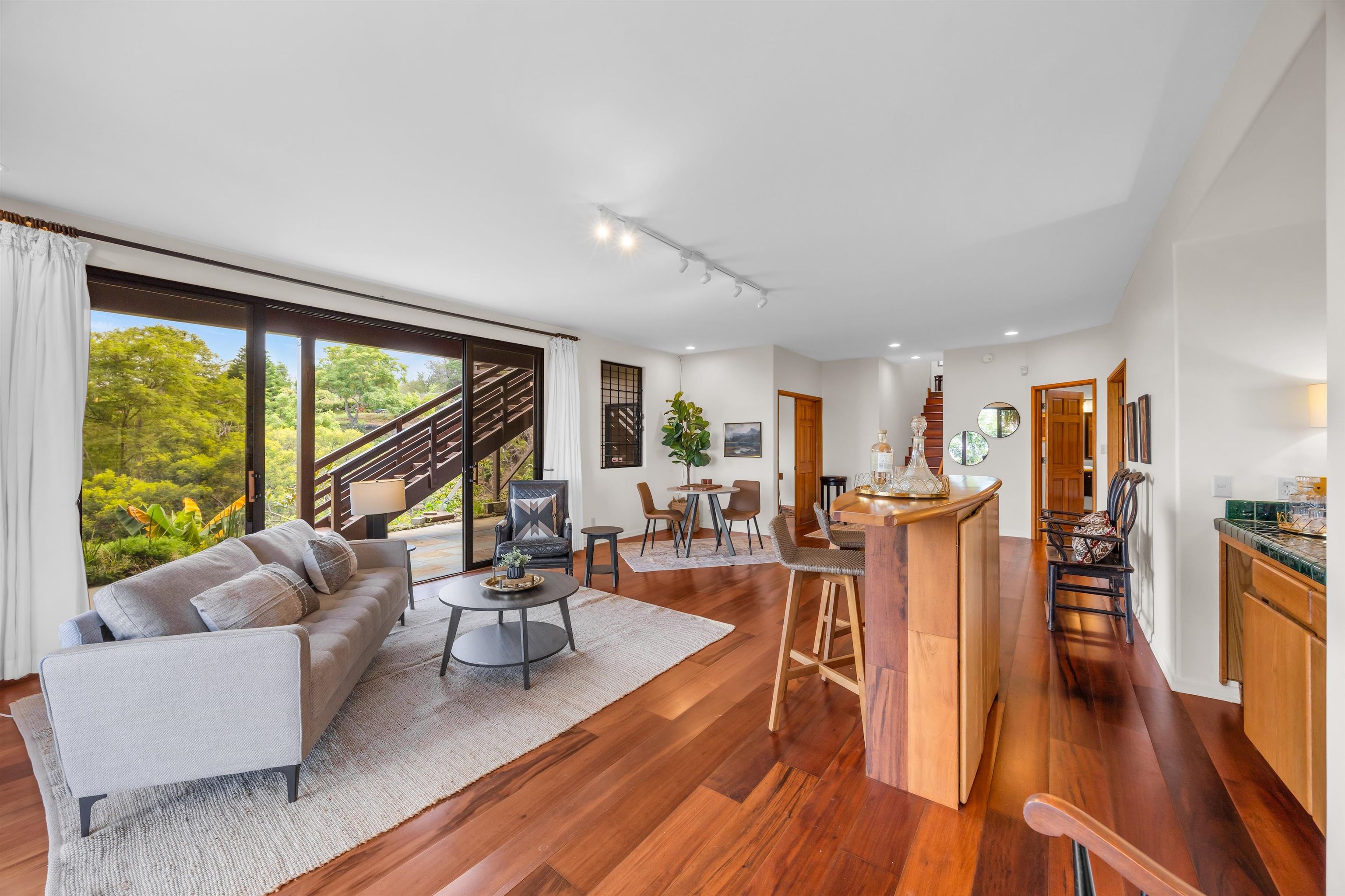 110 Kamehameiki Road Kula, HI 96790 - Photo 41 of 50 a living room with furniture a large window and wooden floor