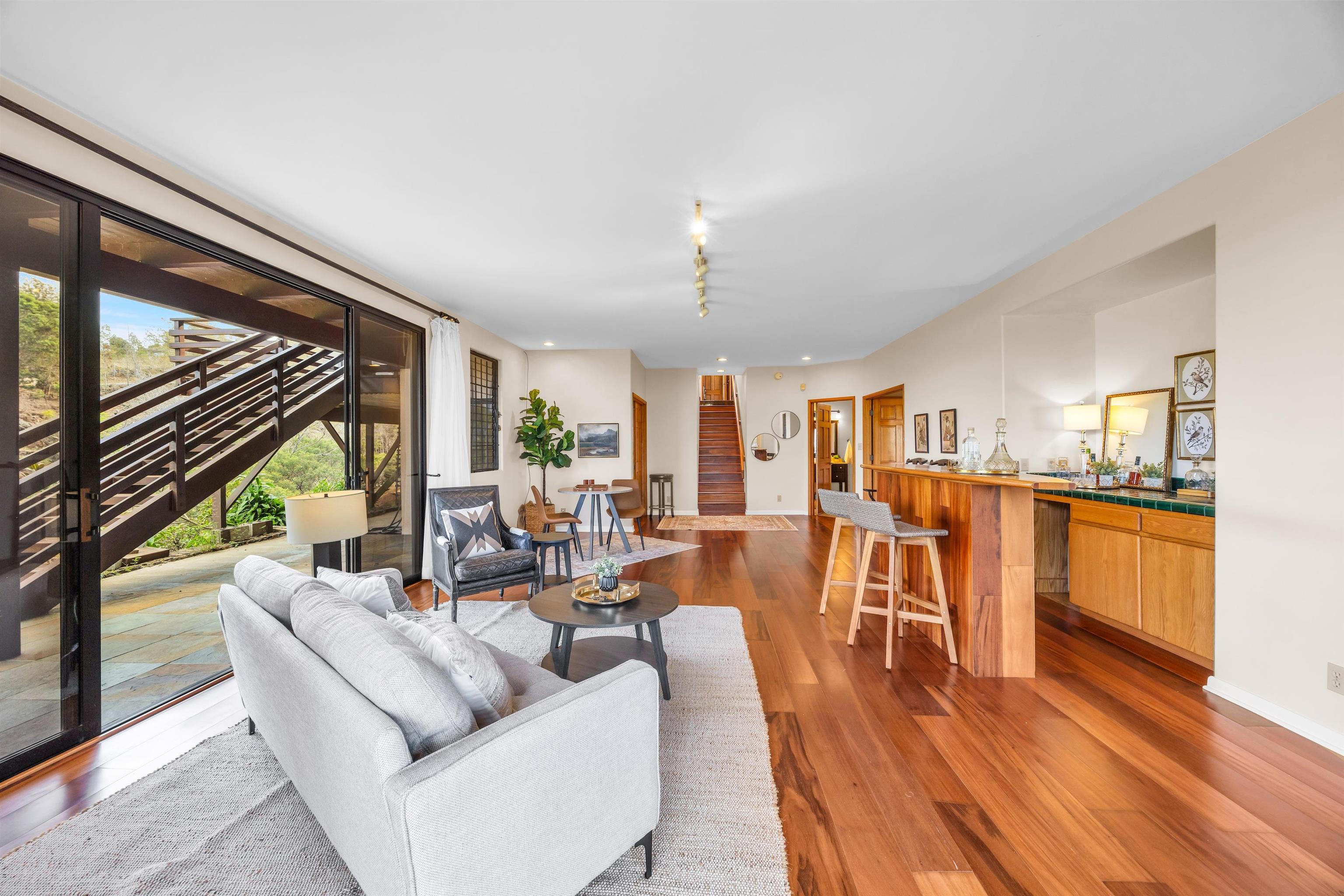 110 Kamehameiki Road Kula, HI 96790 - Photo 42 of 50 a living room with lots of furniture wooden floor and large windows