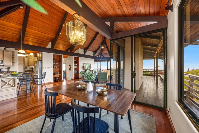 a dining room with furniture and wooden floor