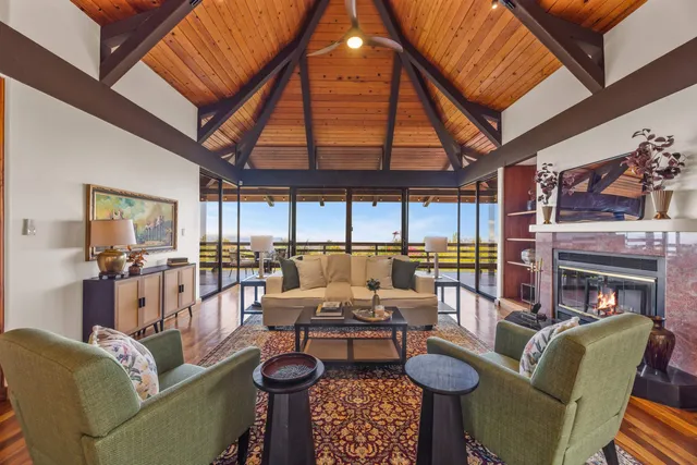 a living room with furniture and a floor to ceiling window