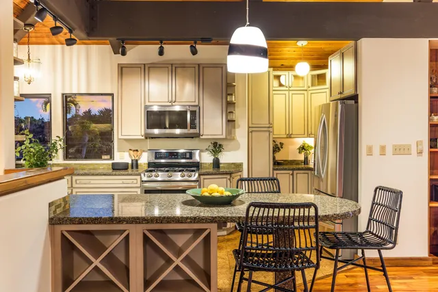 a kitchen with a sink cabinets and window