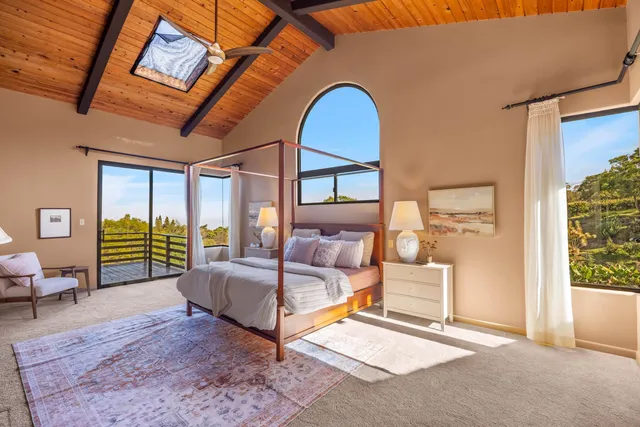 a bedroom with a bed and glass door