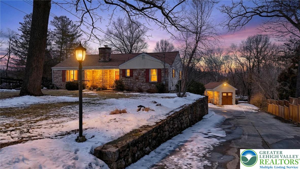 a view of a house with snow yard and a yard