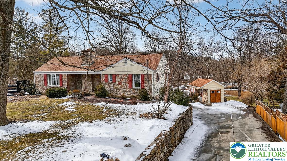 3535 Altonah Road Bethlehem, PA 18017 - Photo 5 of 49 a front view of a house with a yard covered with snow and trees