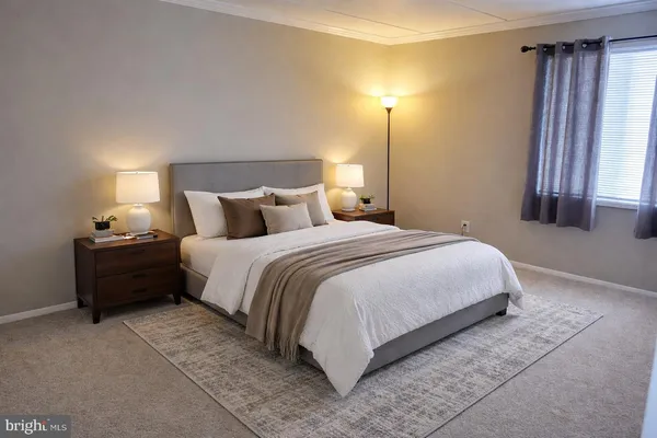 a bedroom with a bed and a lamp