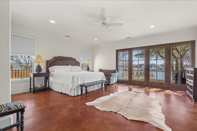 a bedroom with a large bed and a large window