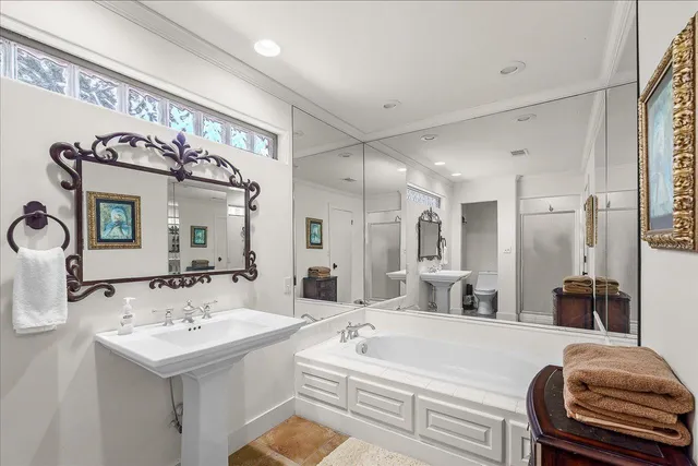 a en suite bathroom with a double vanity sink mirror and