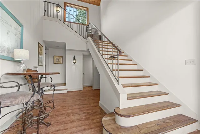 a view of entryway and hall with wooden floor