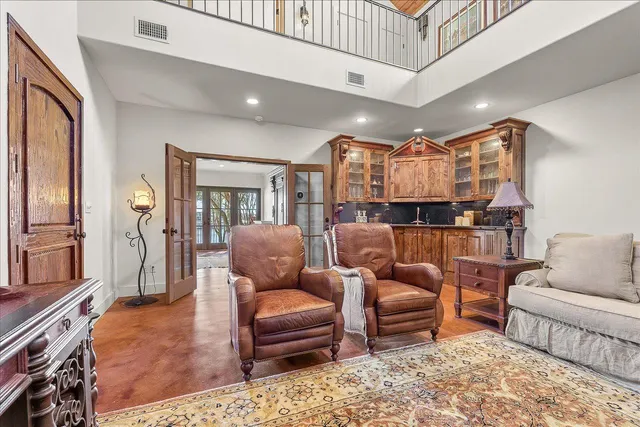 a living room with furniture and a dining table