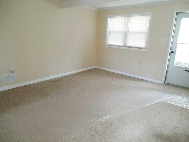 Living Room. You will be delighted with the neutral paint with white trim and Brand NEW plush carpet.