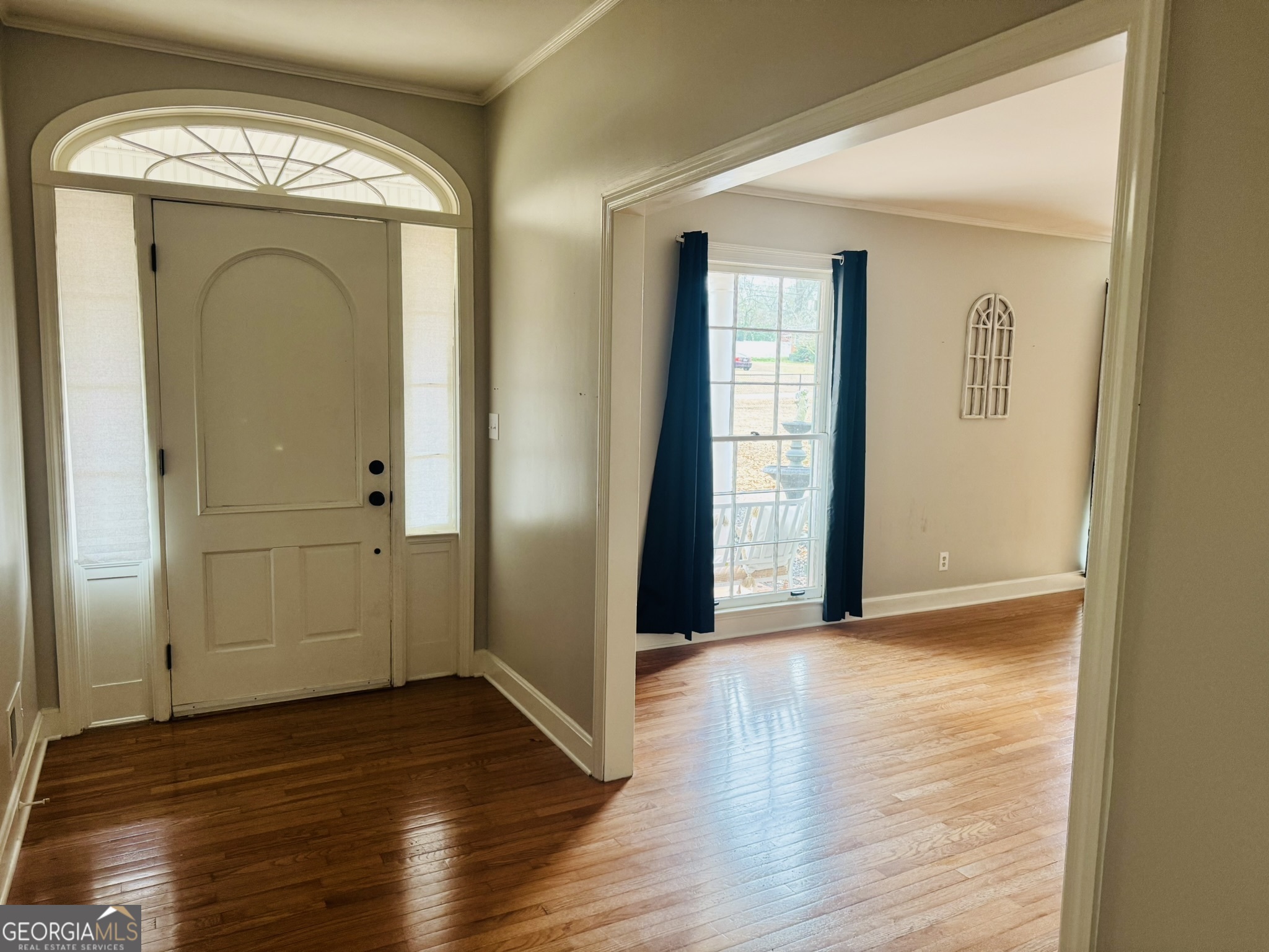 110 Pine Street Barnesville, GA 30204 - Photo 11 of 31 an empty room with wooden floor and mirror