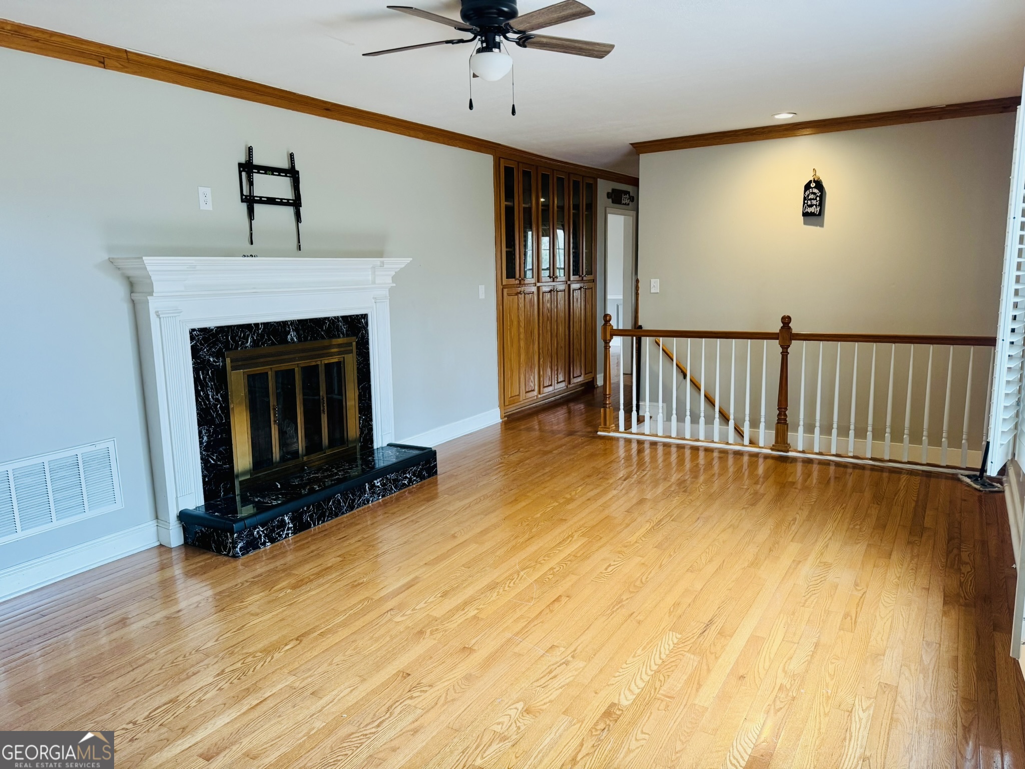 110 Pine Street Barnesville, GA 30204 - Photo 12 of 31 a view of livingroom with fireplace wooden floor and window