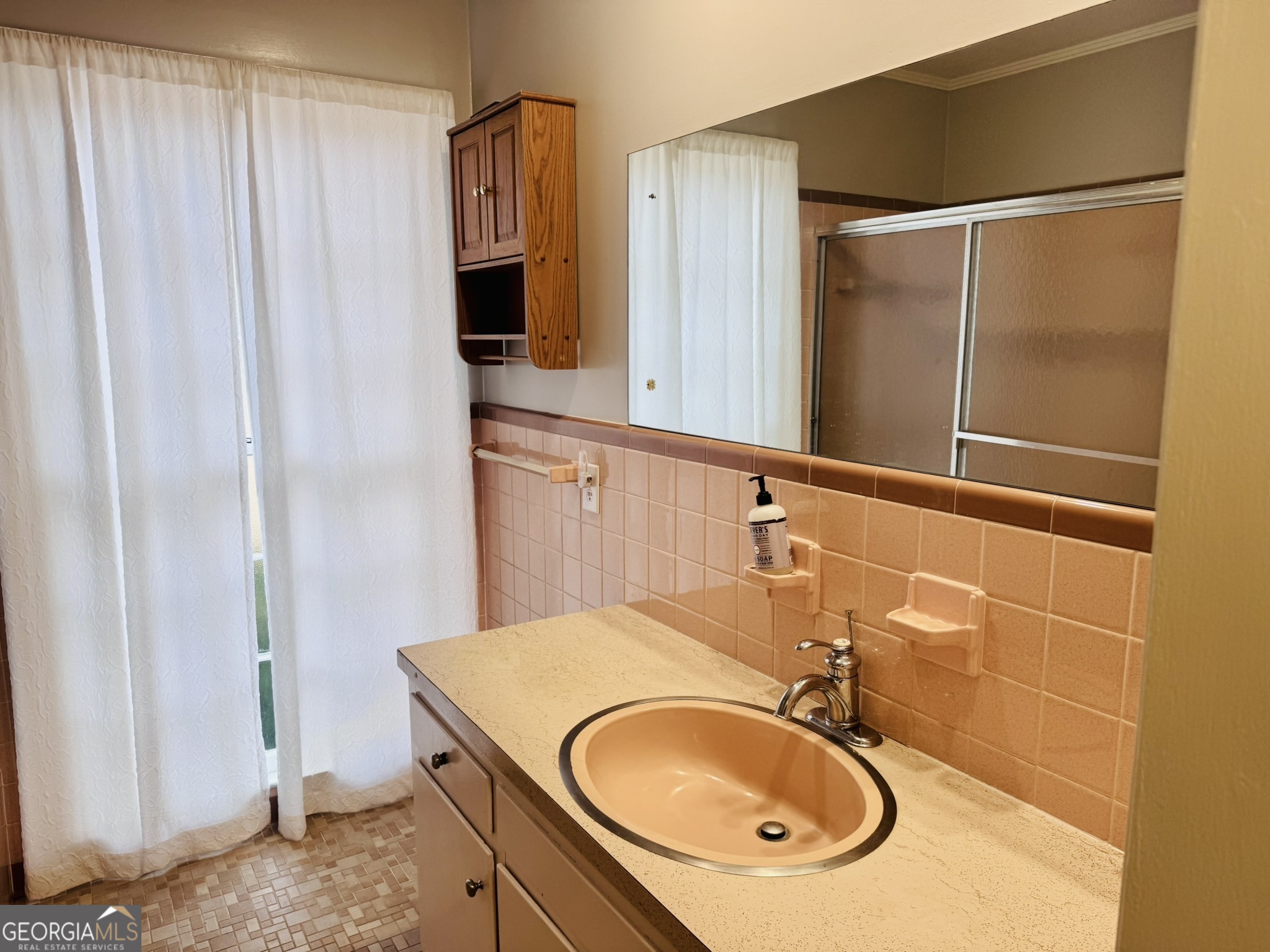 110 Pine Street Barnesville, GA 30204 - Photo 17 of 31 a bathroom with a sink and a mirror