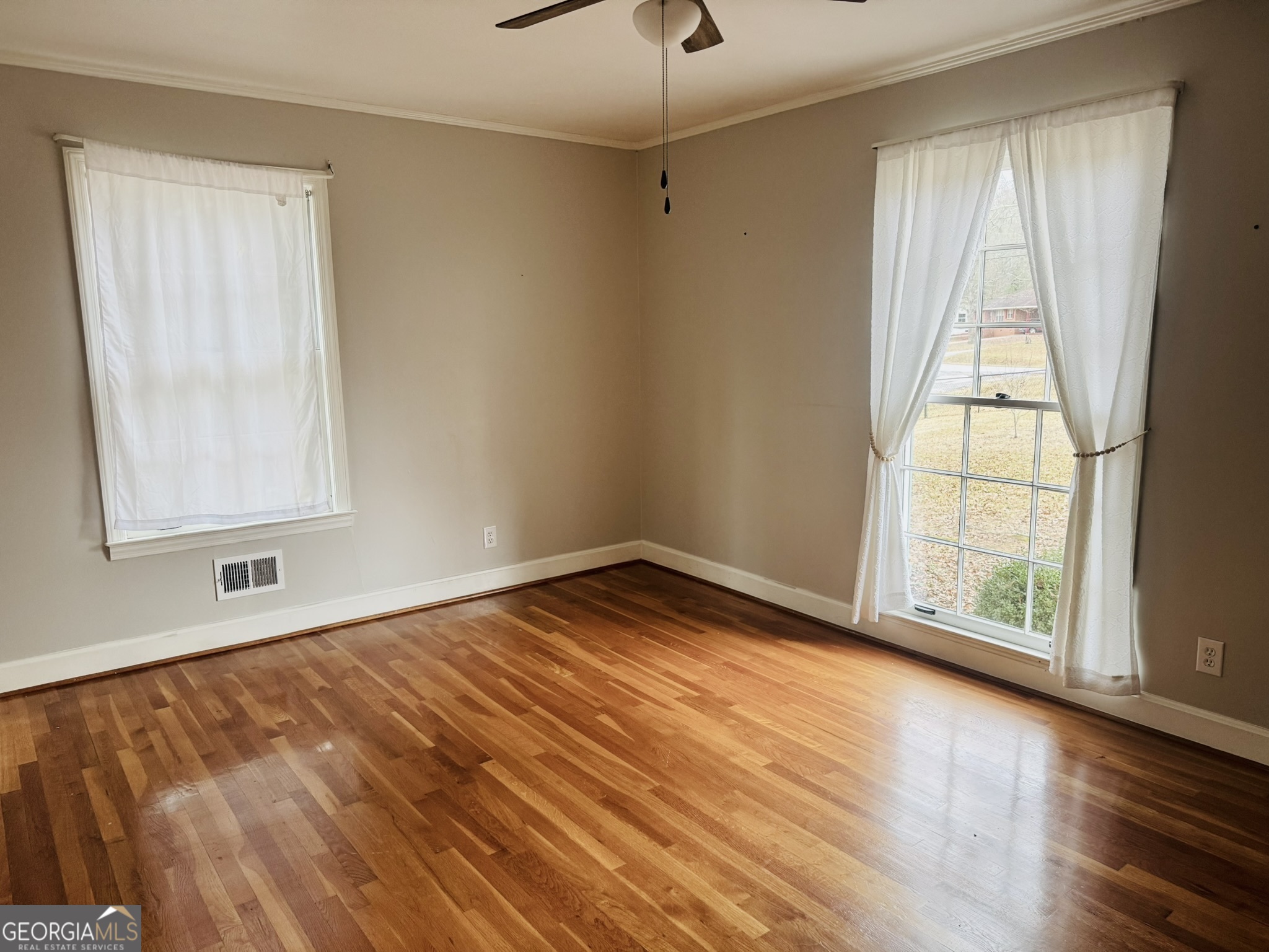 110 Pine Street Barnesville, GA 30204 - Photo 20 of 31 a view of empty room with wooden floor and fan