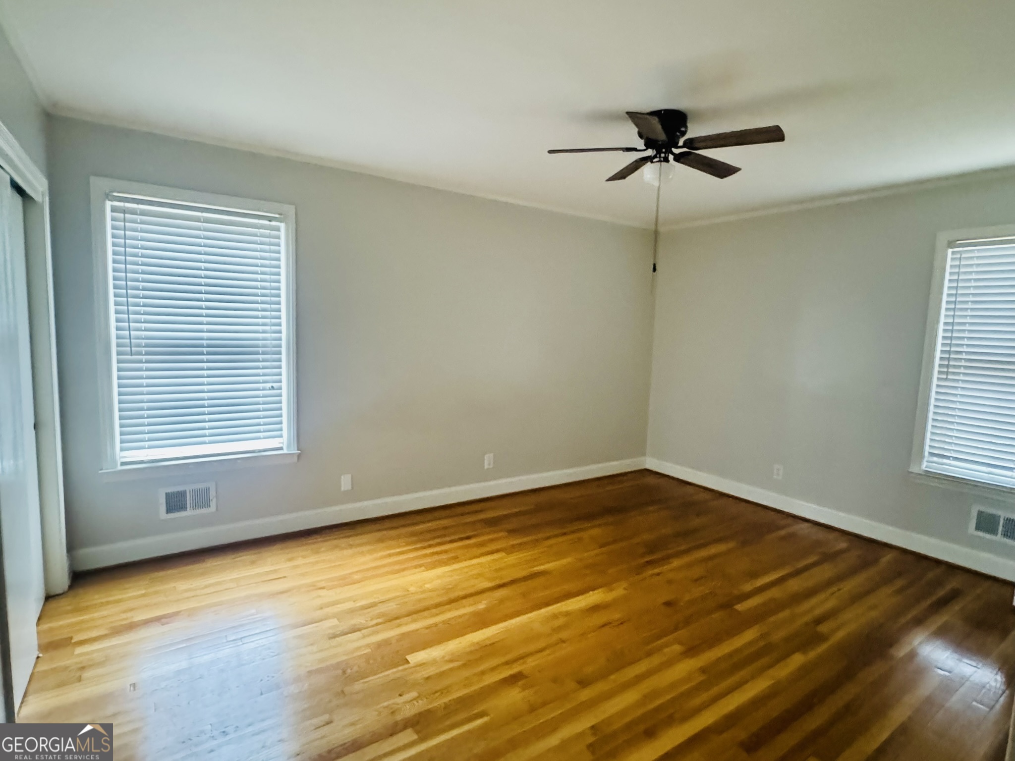 110 Pine Street Barnesville, GA 30204 - Photo 23 of 31 a view of empty room with wooden floor and fan