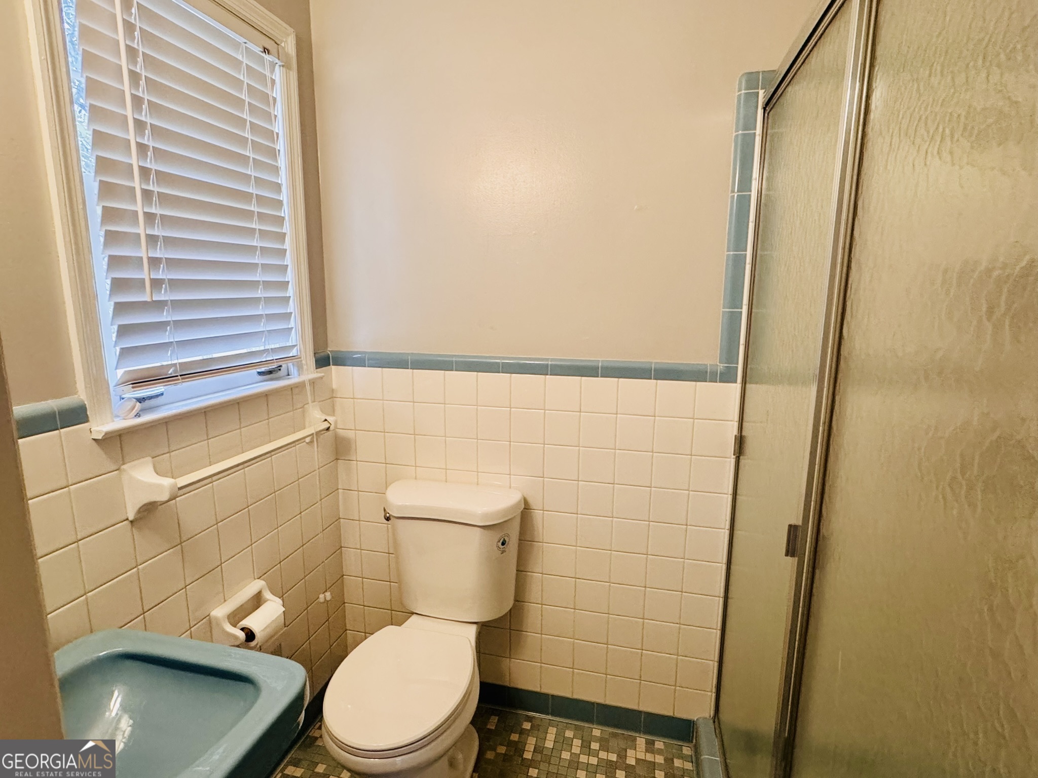 110 Pine Street Barnesville, GA 30204 - Photo 25 of 31 a white toilet sitting next to a shower in a bathroom