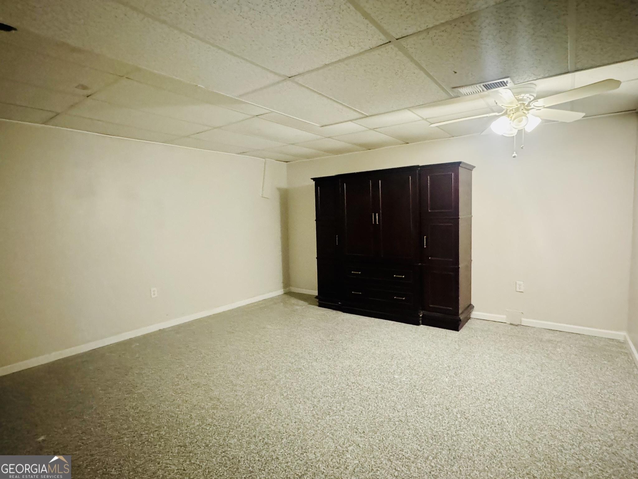 110 Pine Street Barnesville, GA 30204 - Photo 29 of 31 a big room with a cabinet and a chandelier fan