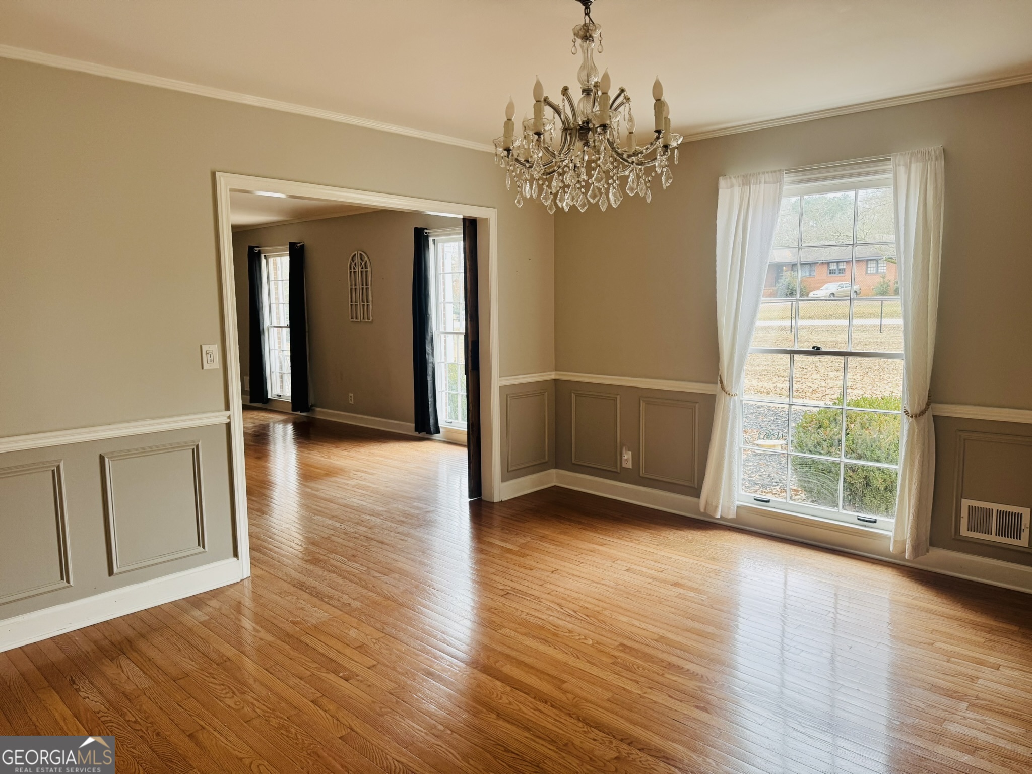 110 Pine Street Barnesville, GA 30204 - Photo 7 of 31 a view of an empty room with wooden floor and a window