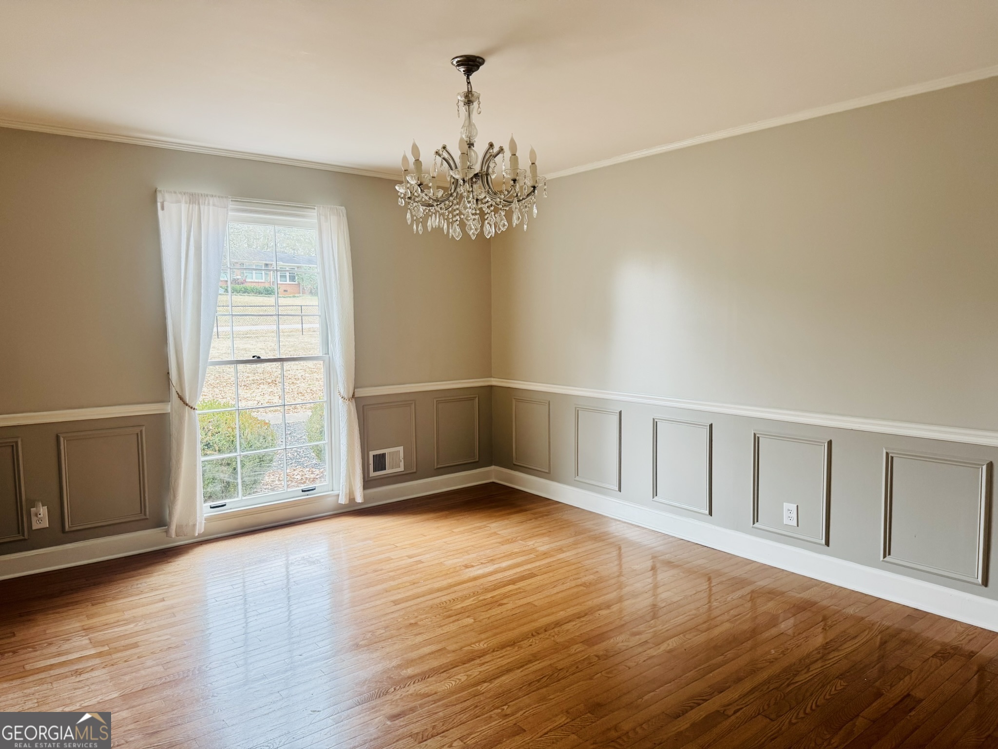 110 Pine Street Barnesville, GA 30204 - Photo 8 of 31 a view of an empty room with wooden floor and a window