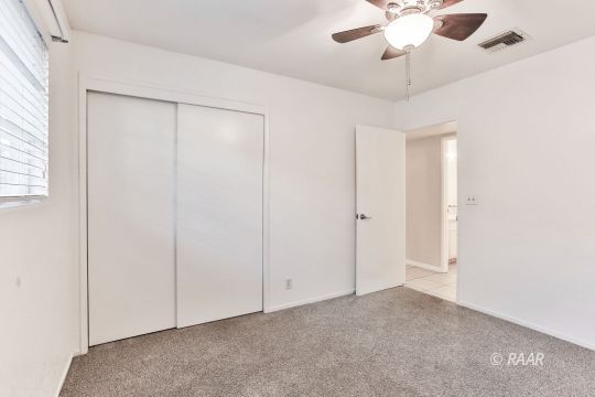 528 South Sorrel Street Ridgecrest, CA 93555 - Photo 16 of 27 an empty room with a ceiling fan and a window