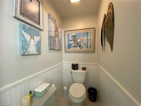 a white toilet sitting next to a bathroom sink