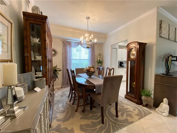 a view of a dining room with furniture and chandelier