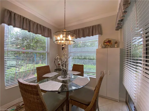 a view of a dining room with furniture wooden floor and chandelier