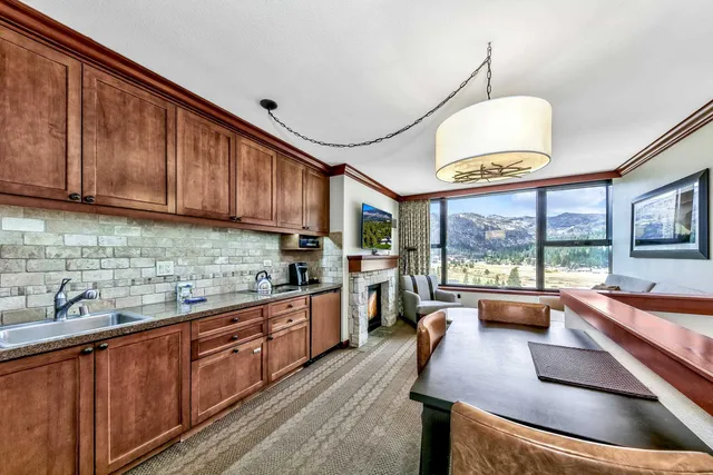 a kitchen with stainless steel appliances granite countertop sink stove and large window
