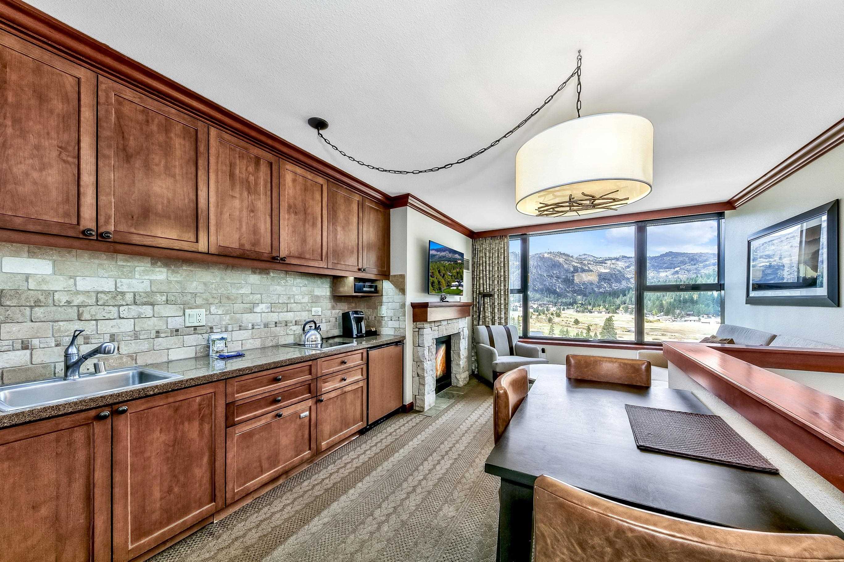 400 Resort Road, Unit 958 Olympic Valley, CA 96146 - Photo 13 of 21 a kitchen with stainless steel appliances granite countertop sink stove and large window