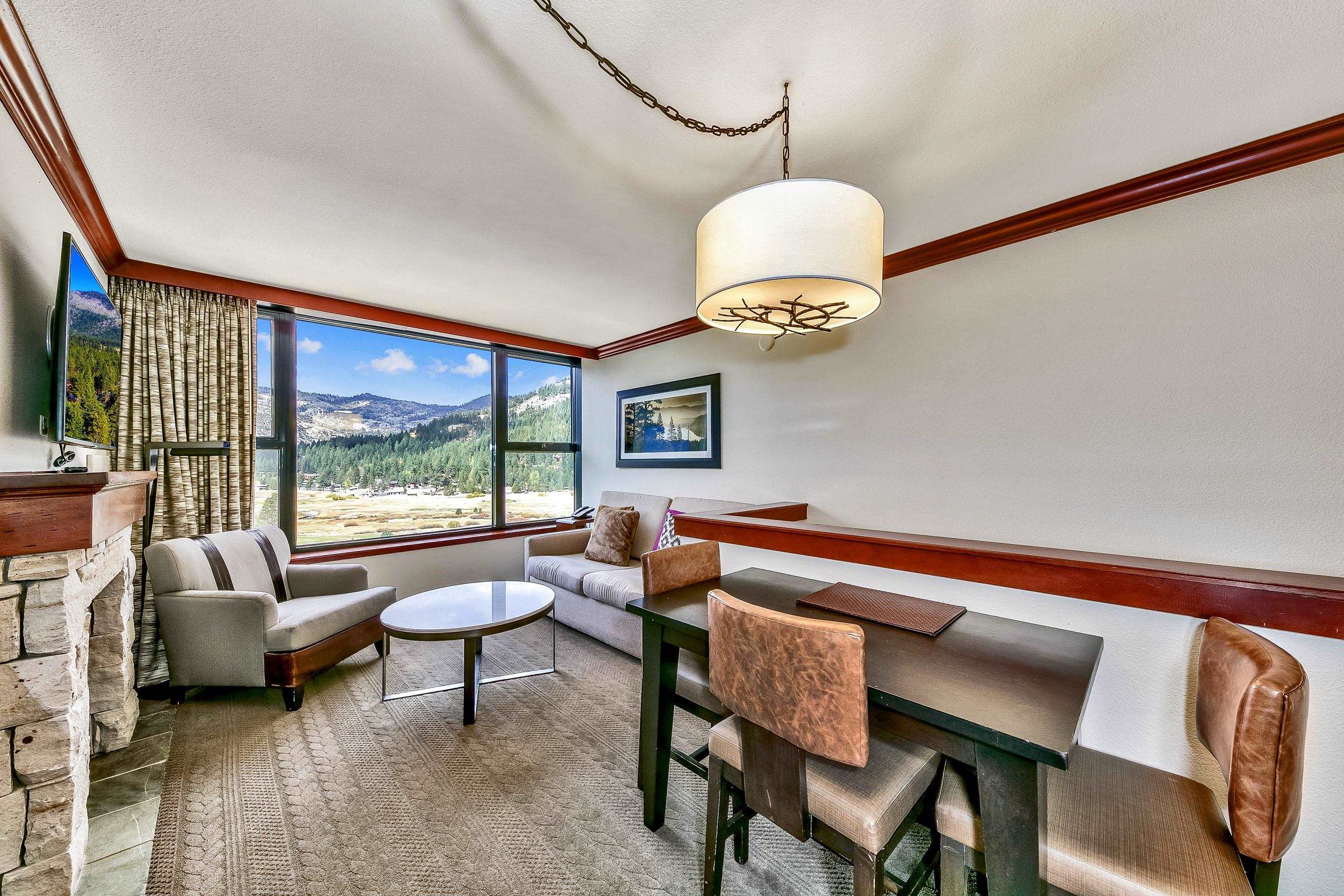 400 Resort Road, Unit 958 Olympic Valley, CA 96146 - Photo 2 of 21 a dining room with furniture and a floor to ceiling window