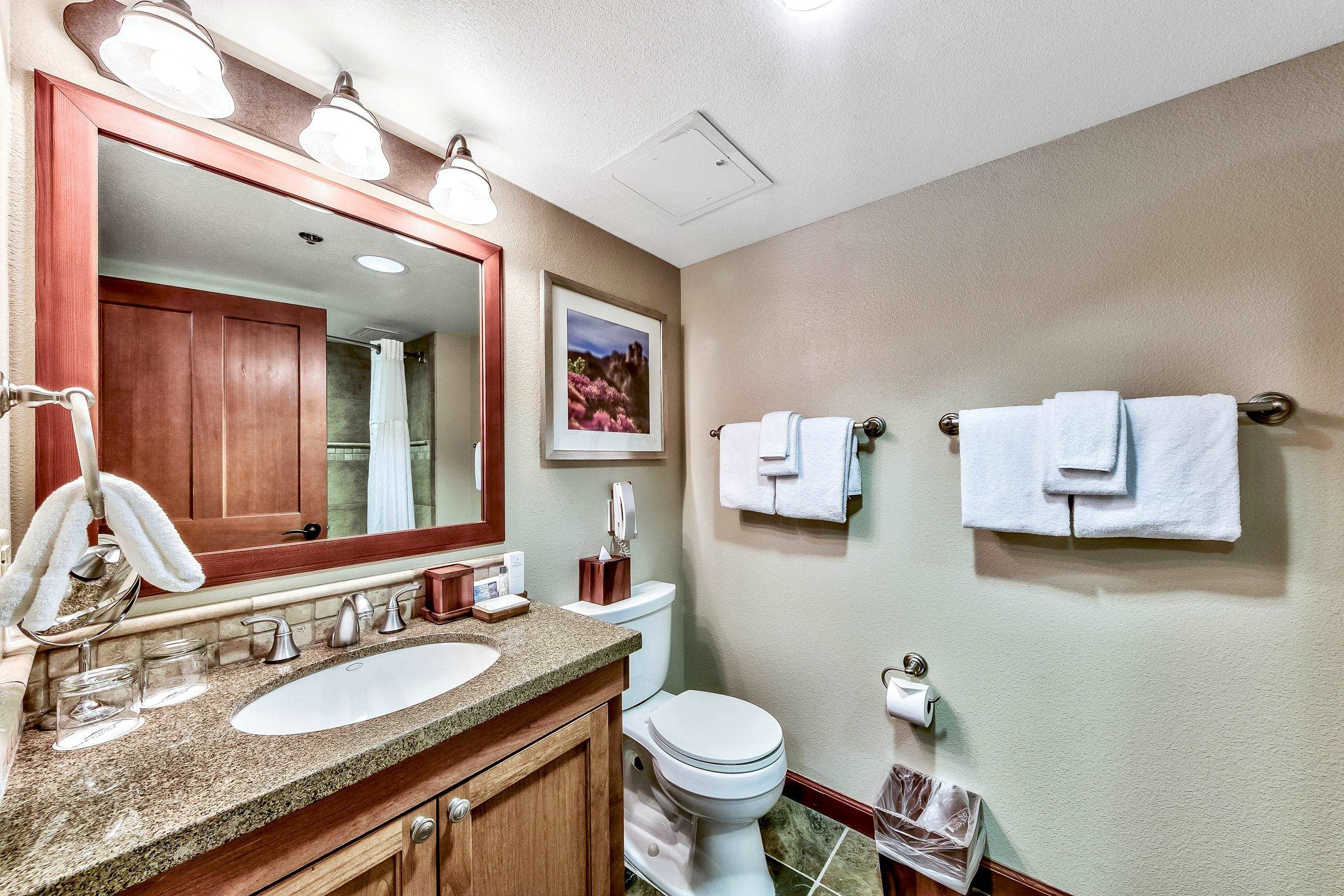 400 Resort Road, Unit 958 Olympic Valley, CA 96146 - Photo 6 of 21 a bathroom with a granite countertop sink mirror and toilet