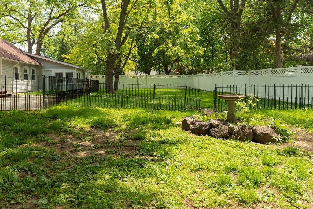3711 Highcrest Road Rockford, IL 61107 - Photo 14 of 58 a view of a backyard with plants and large trees