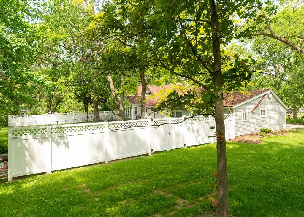3711 Highcrest Road Rockford, IL 61107 - Photo 10 of 58 a view of an house with backyard space and a tree