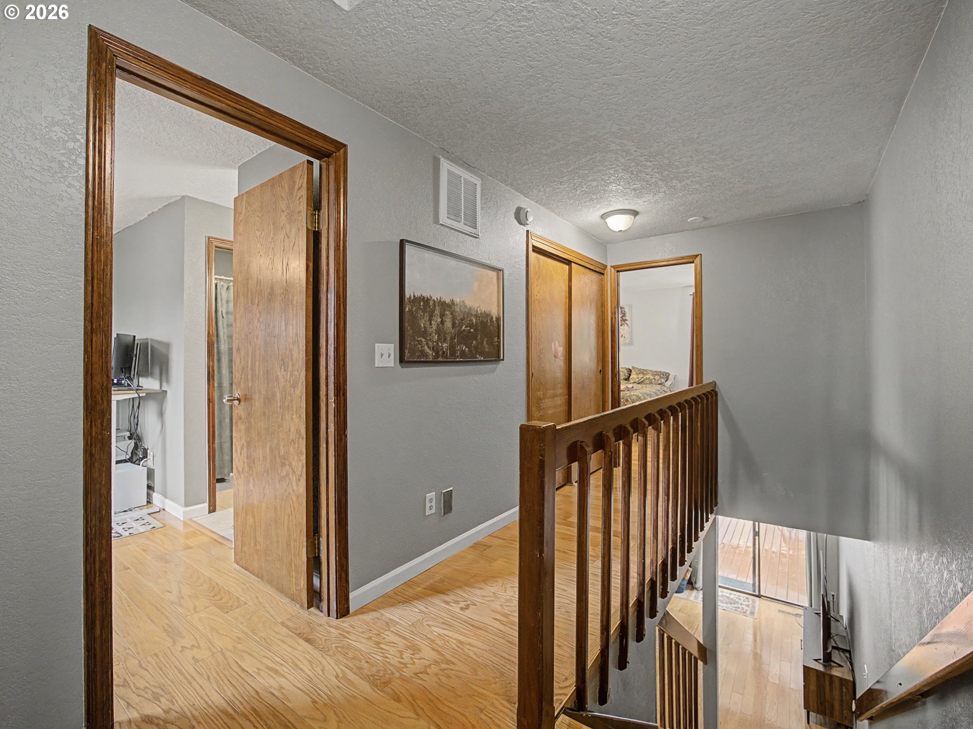 3214 Northeast 29th Street Gresham, OR 97030 - Photo 15 of 42 a view of a hallway with wooden floor and staircase