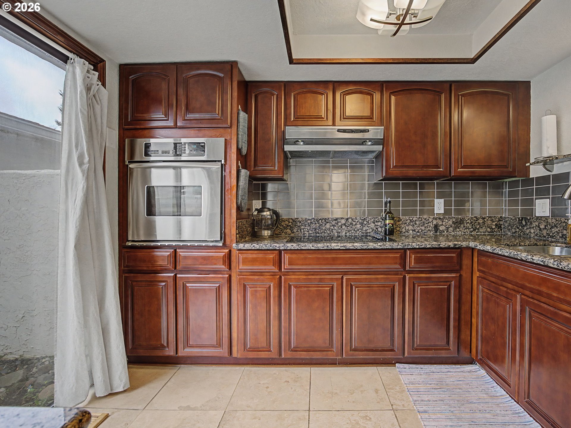 3214 Northeast 29th Street Gresham, OR 97030 - Photo 5 of 42 a kitchen with stainless steel appliances granite countertop a refrigerator and cabinets