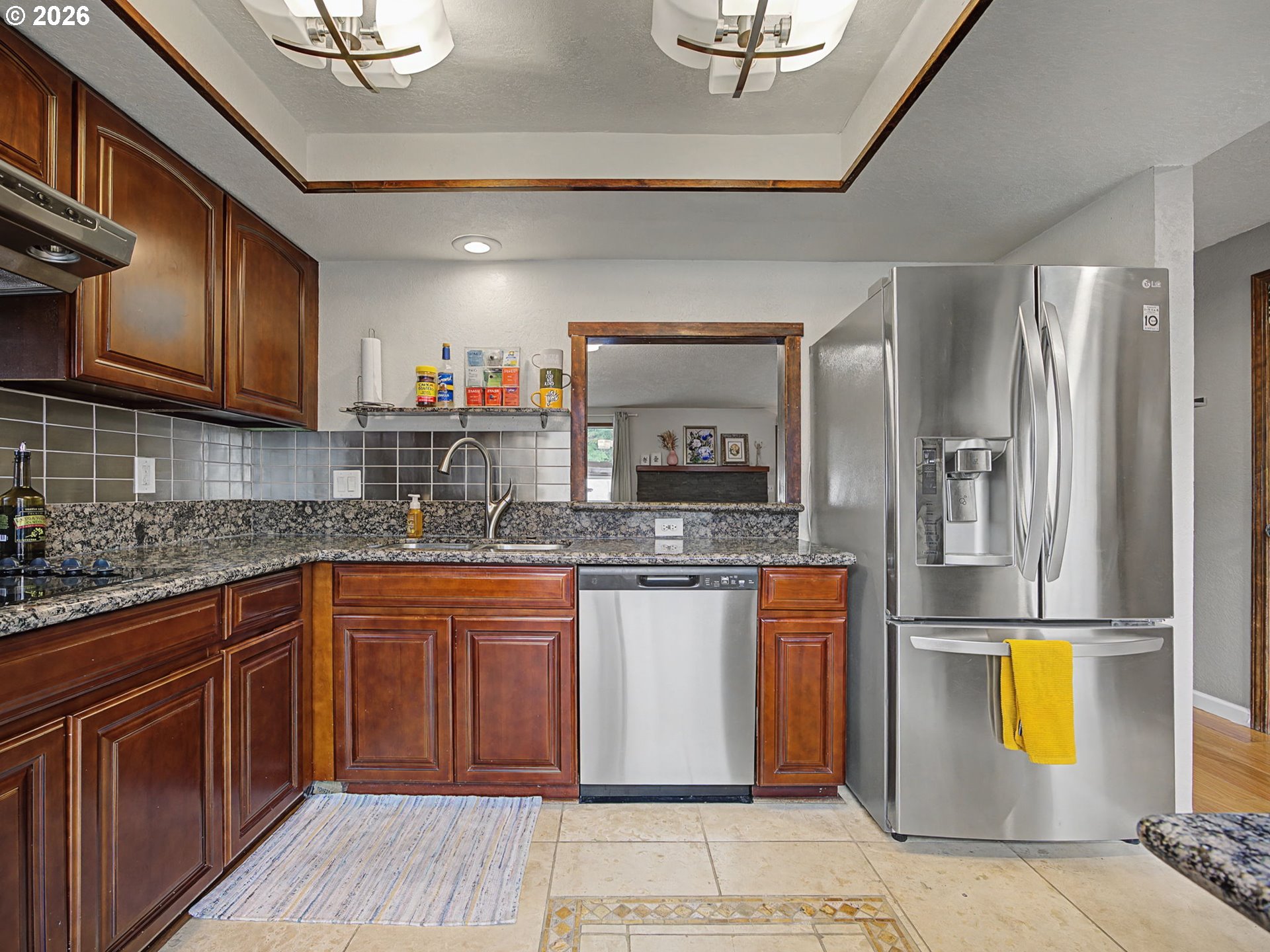 3214 Northeast 29th Street Gresham, OR 97030 - Photo 6 of 42 a kitchen with stainless steel appliances granite countertop a refrigerator a sink dishwasher a stove and white countertops with wooden floor