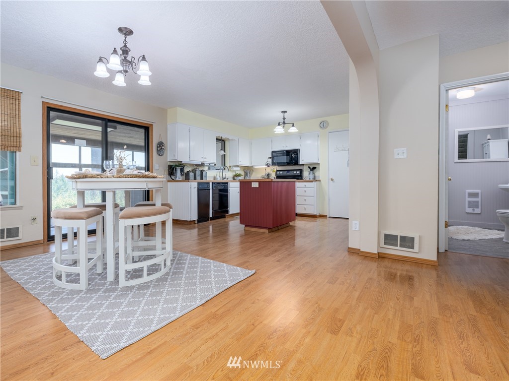 765 Eadon Road Toledo, WA 98591 - Photo 4 of 40 a living room with kitchen island furniture and a chandelier