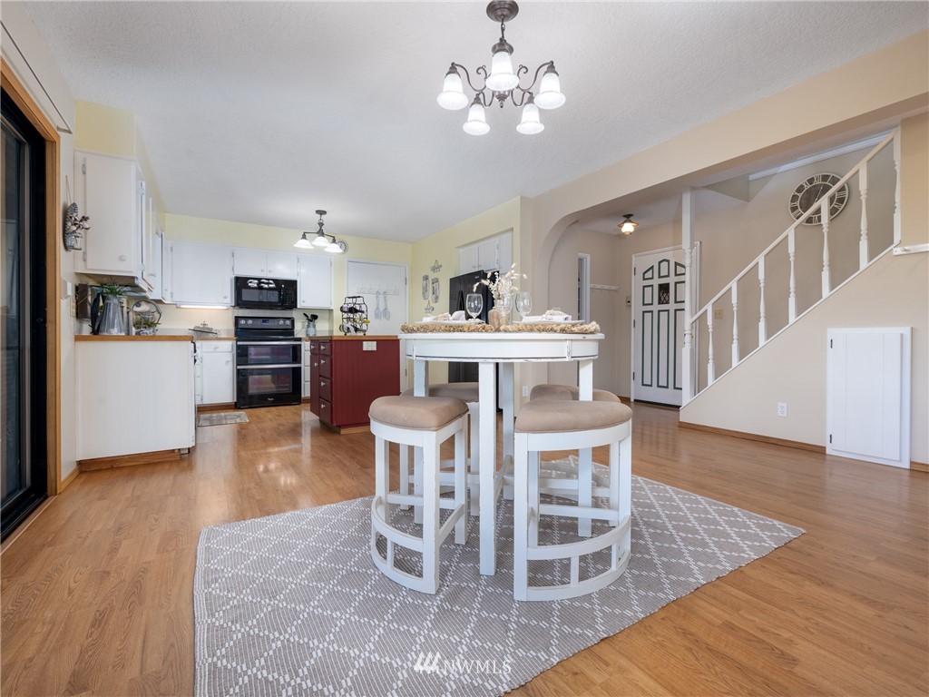 765 Eadon Road Toledo, WA 98591 - Photo 5 of 40 a view of a dining room with furniture and wooden floor