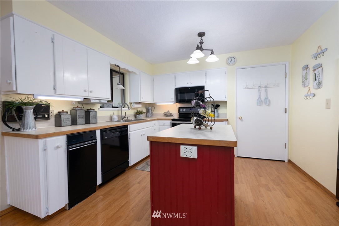 765 Eadon Road Toledo, WA 98591 - Photo 6 of 40 a kitchen with kitchen island granite countertop a sink cabinets and stainless steel appliances