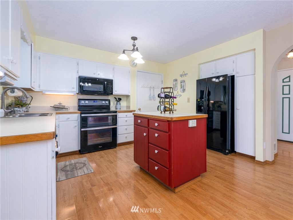 765 Eadon Road Toledo, WA 98591 - Photo 7 of 40 a kitchen with stainless steel appliances a refrigerator and a stove top oven