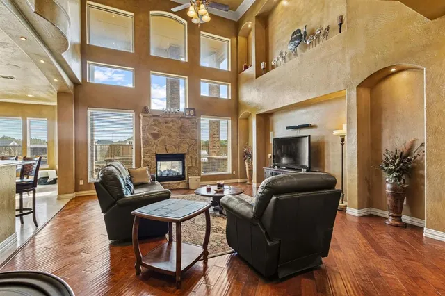 a living room with furniture fireplace and wooden floor