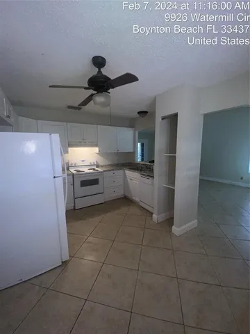 a kitchen with granite countertop cabinets and white appliances