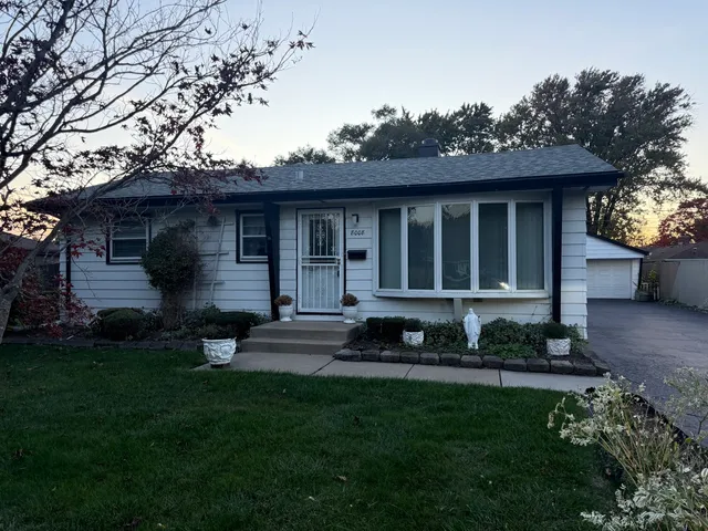 a view of a house with a yard and plants