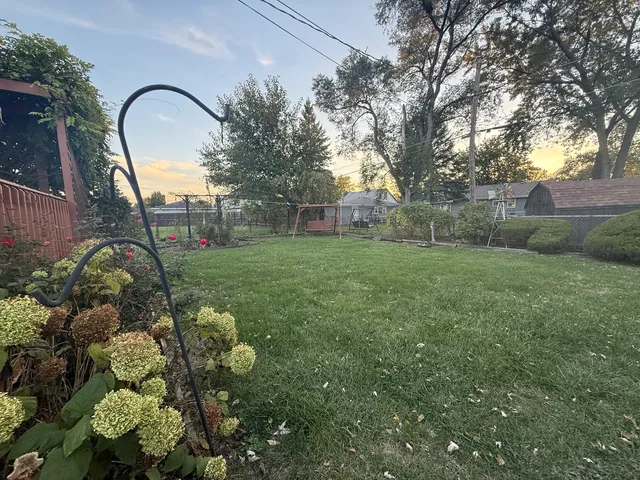 a backyard of a house with lots of green space and plants